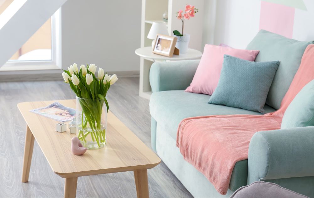 blue couch with pink and blue pillows