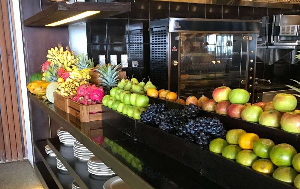 Buffet table with boxes of fruits