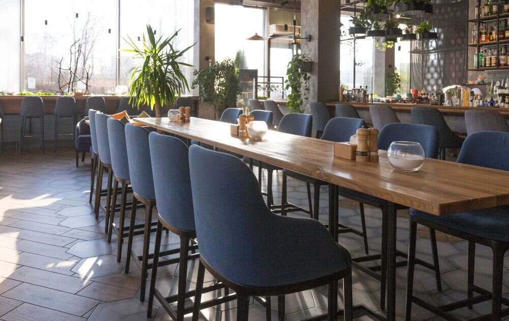 coffee shop with a rustic long table and gray chairs