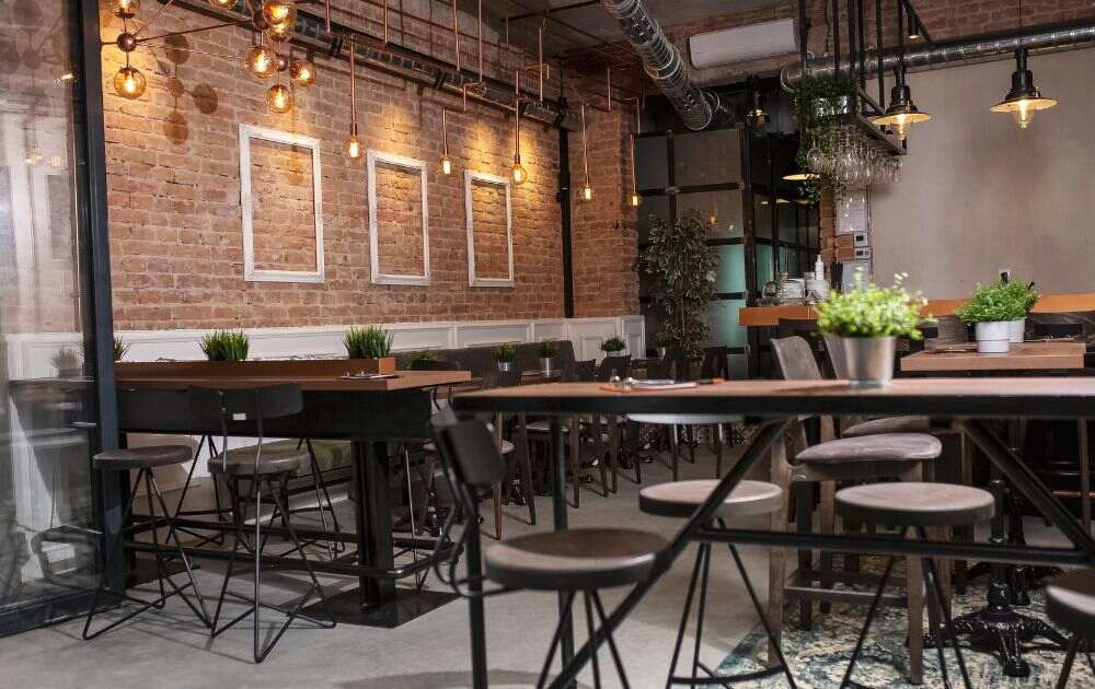 coffee shop with brick walls and wood tables and chairs